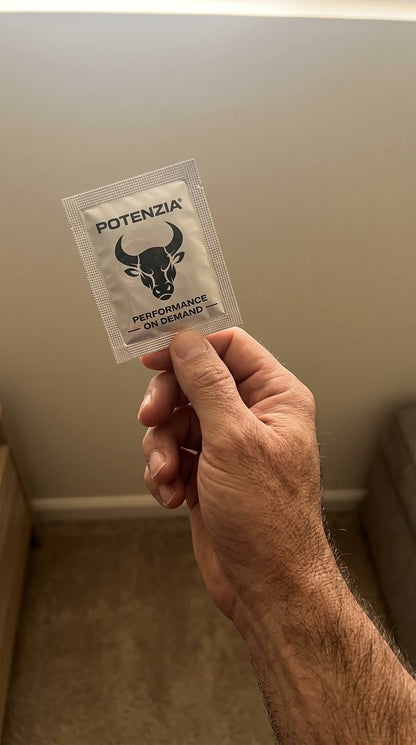 Hand holding a single Potenzia film strip sachet